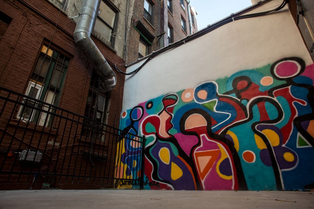 A newly-installed mural in the backyard of 194 First Avenue clashes with the buildings' older fixtures.<br>